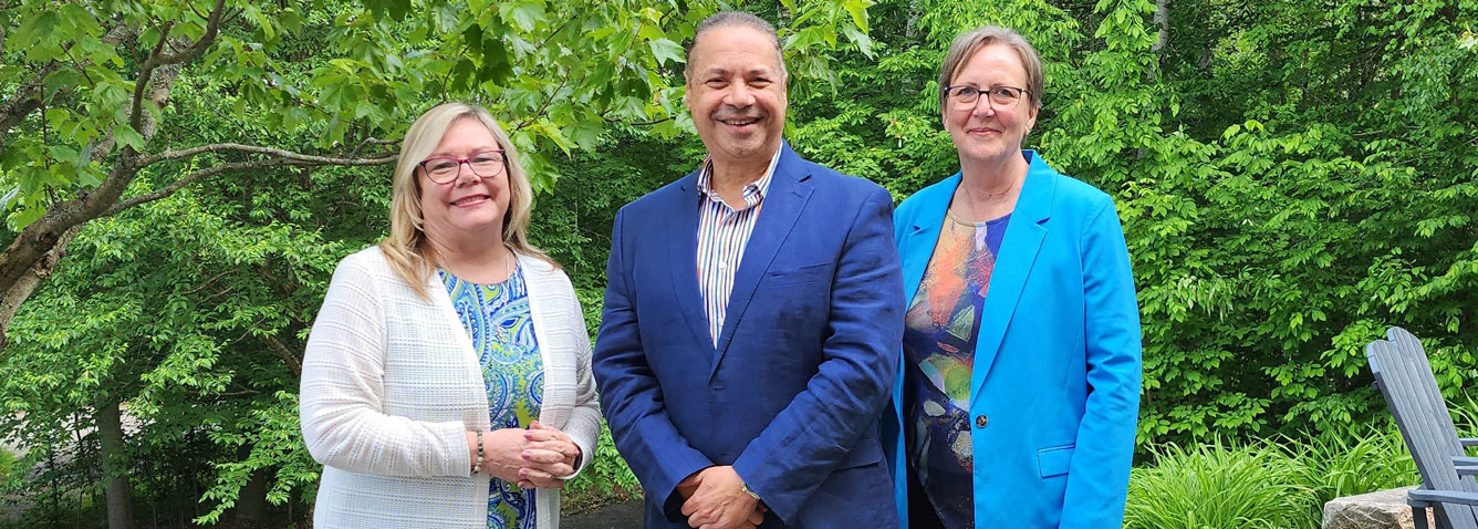 President & CEO Cheryl Harrison, Chief of Staff Dr. Khaled Abdel-Razek, Board Chair Moreen Miller standing side by side, outside.