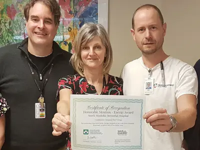 Staff holding Green Hospital Scorecard certificate