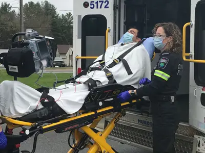 Two paramedics with a patient on a stretcher